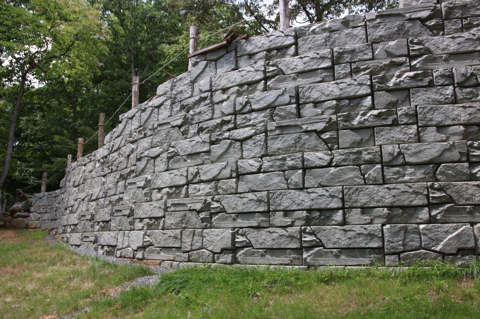 Tall reinforced retaining wall installation